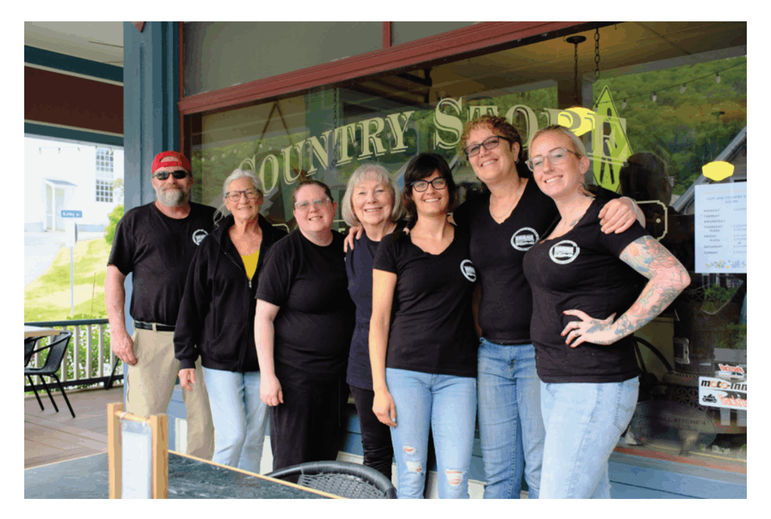 Group of people with black shirts standing on a porch
